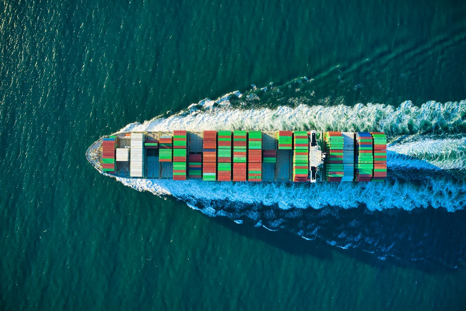 Container ship sailing on open water, seen from above